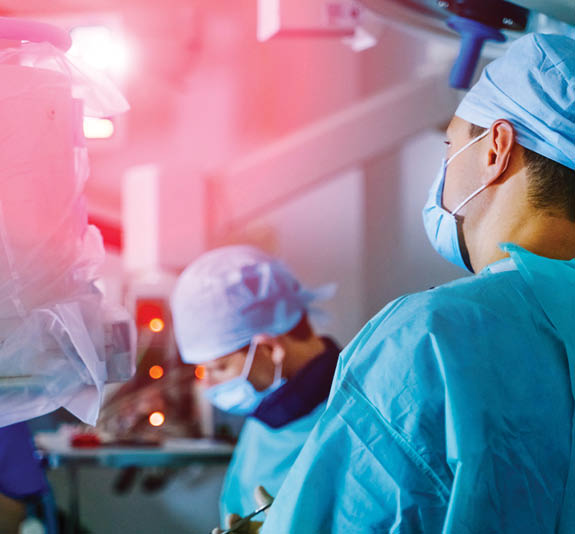 Group of surgeons in operating room with surgery equipment. Medical background